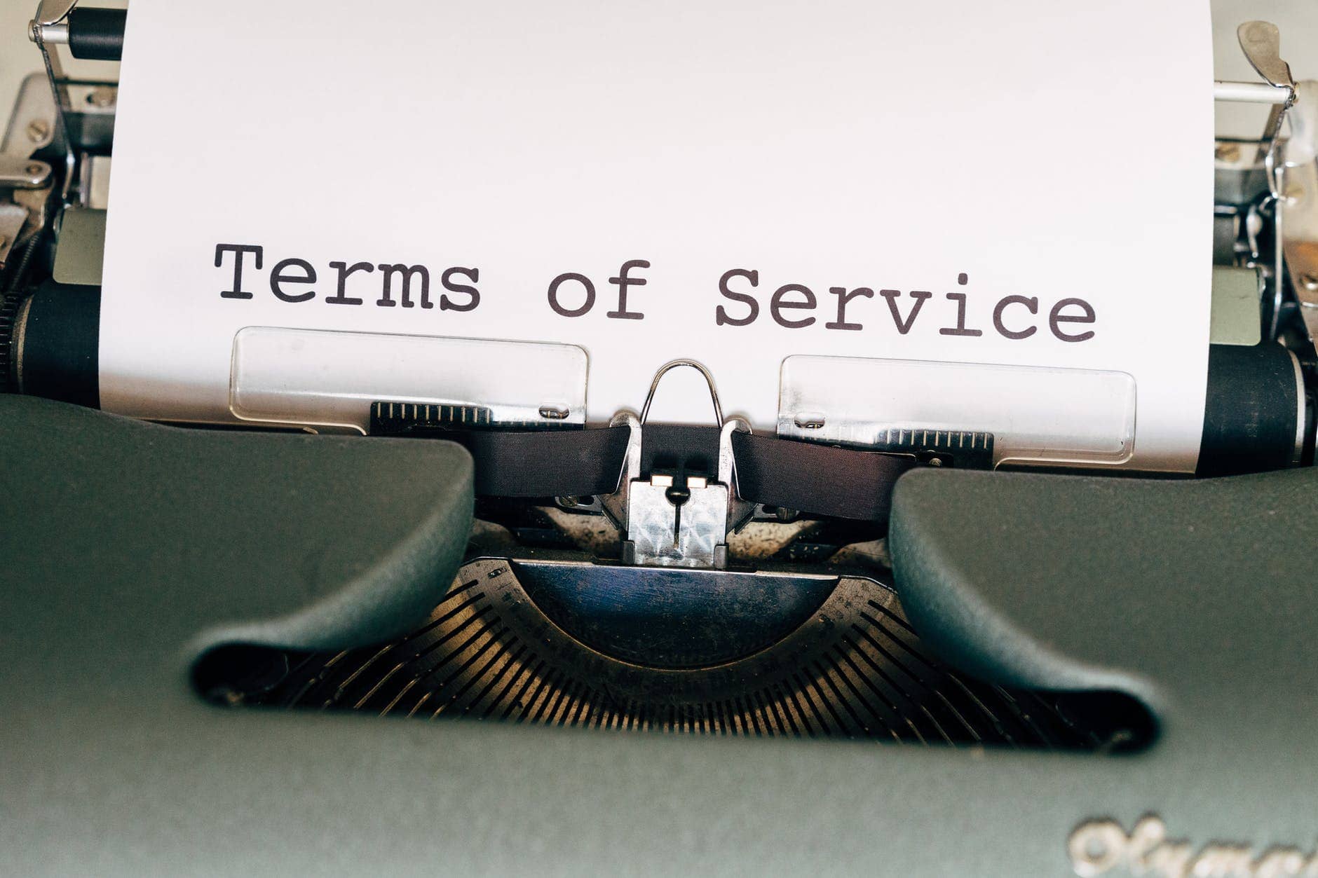 terms of service black and green typewriter with white paper